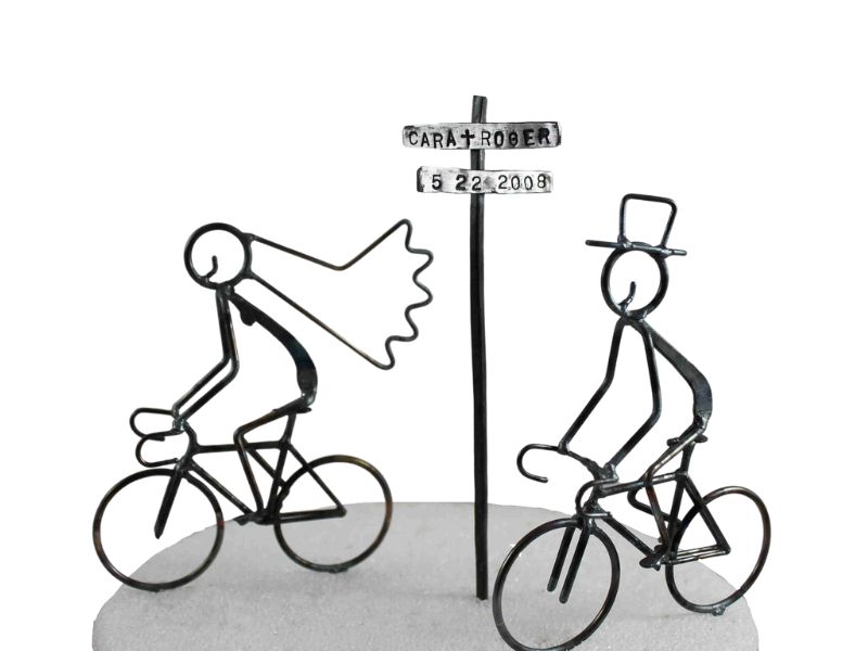 bride and groom on road bike cake toppers with sign